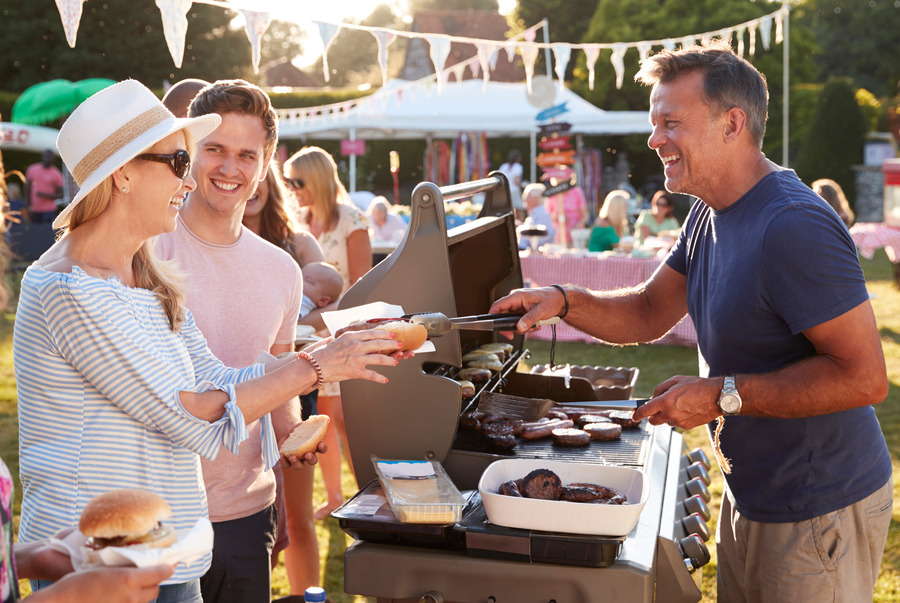 Crowd of people around a barbeque