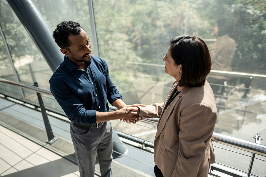 Man shaking woman's hand