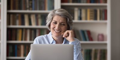 Lady smiling and using a laptop