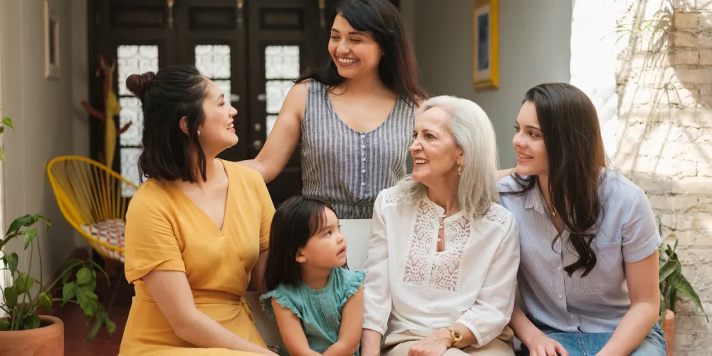 Group of intergenerational Mexican women looking at one another