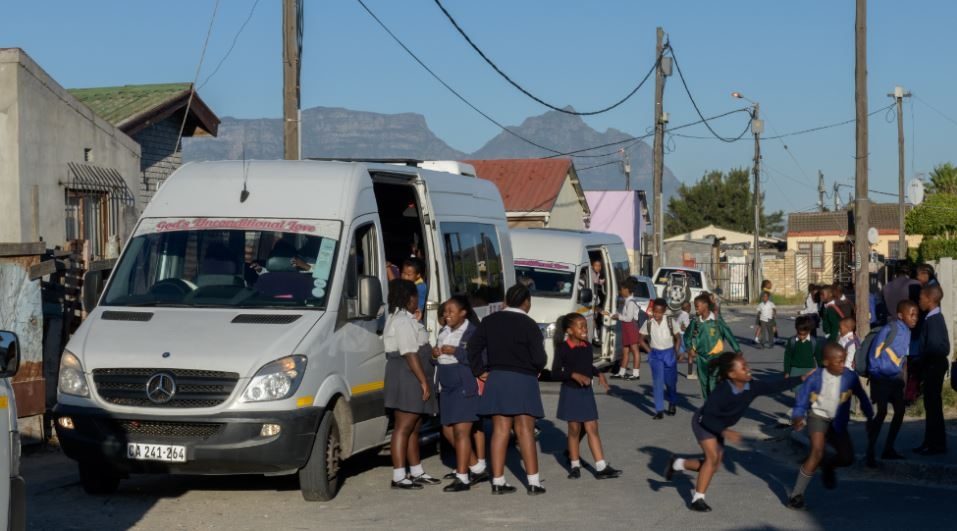 Image of schoolchildren getting into minibus. Copyright ChildSafe