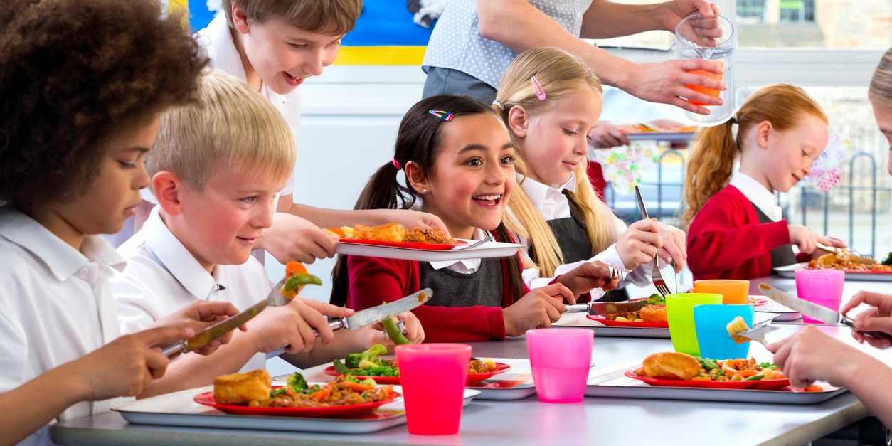 Institutional nutrition policies - children eating lunch in school cafe