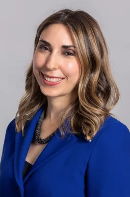 Headshot of Dr Elisa Pineda in blue jacket